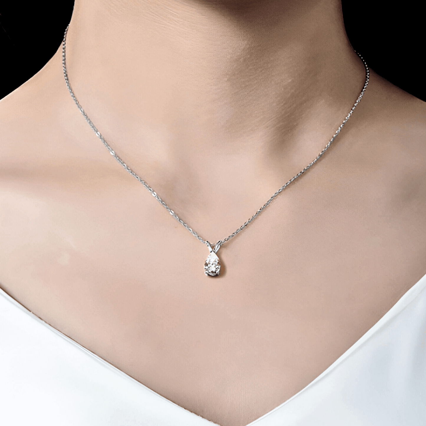 Mira Pendant 1.5ct - Teardrop necklace in polished 925 sterling silver with 1.5 carats of white moissanite. worn on model's neck.