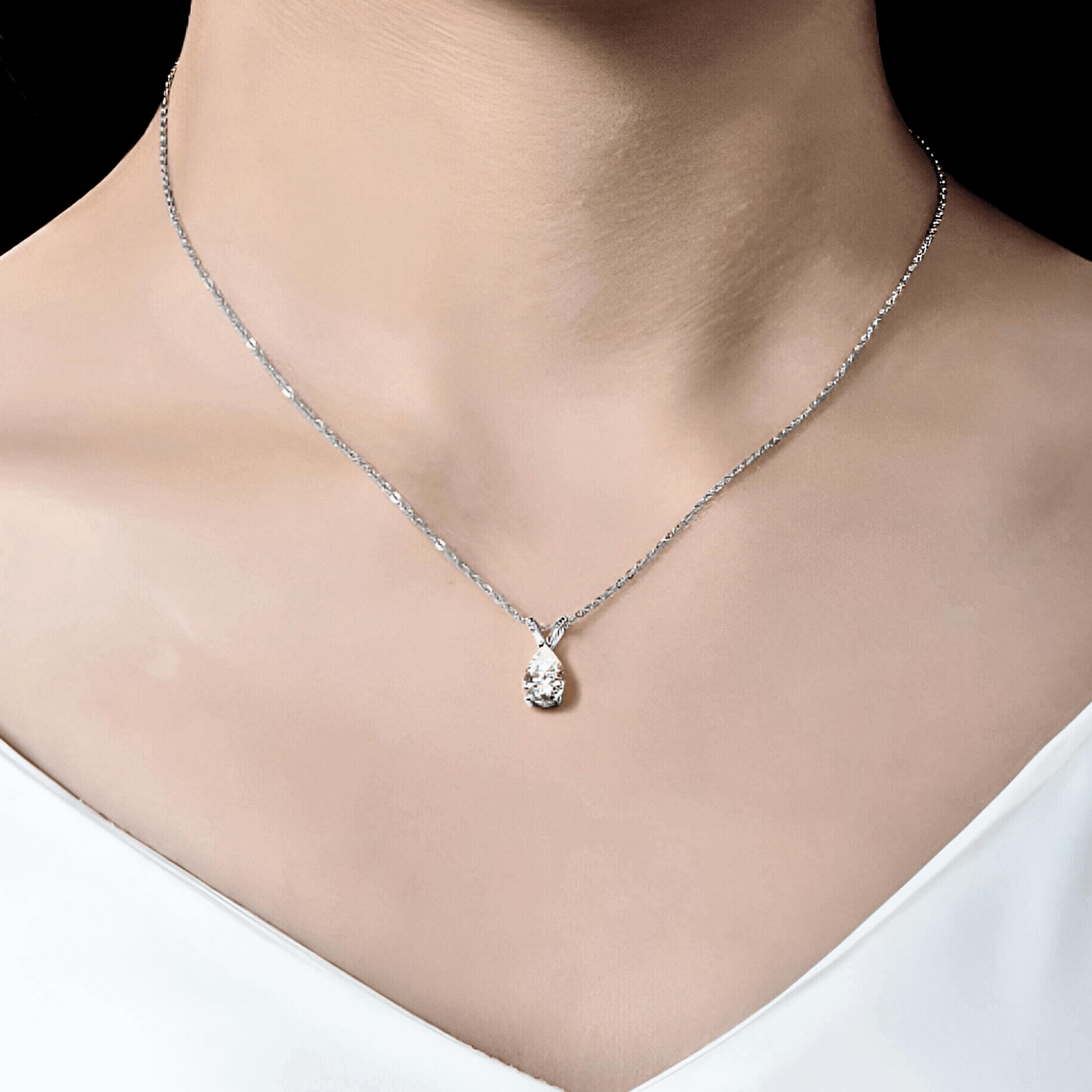 Mira Pendant 1.5ct - Teardrop necklace in polished 925 sterling silver with 1.5 carats of white moissanite. worn on model's neck.