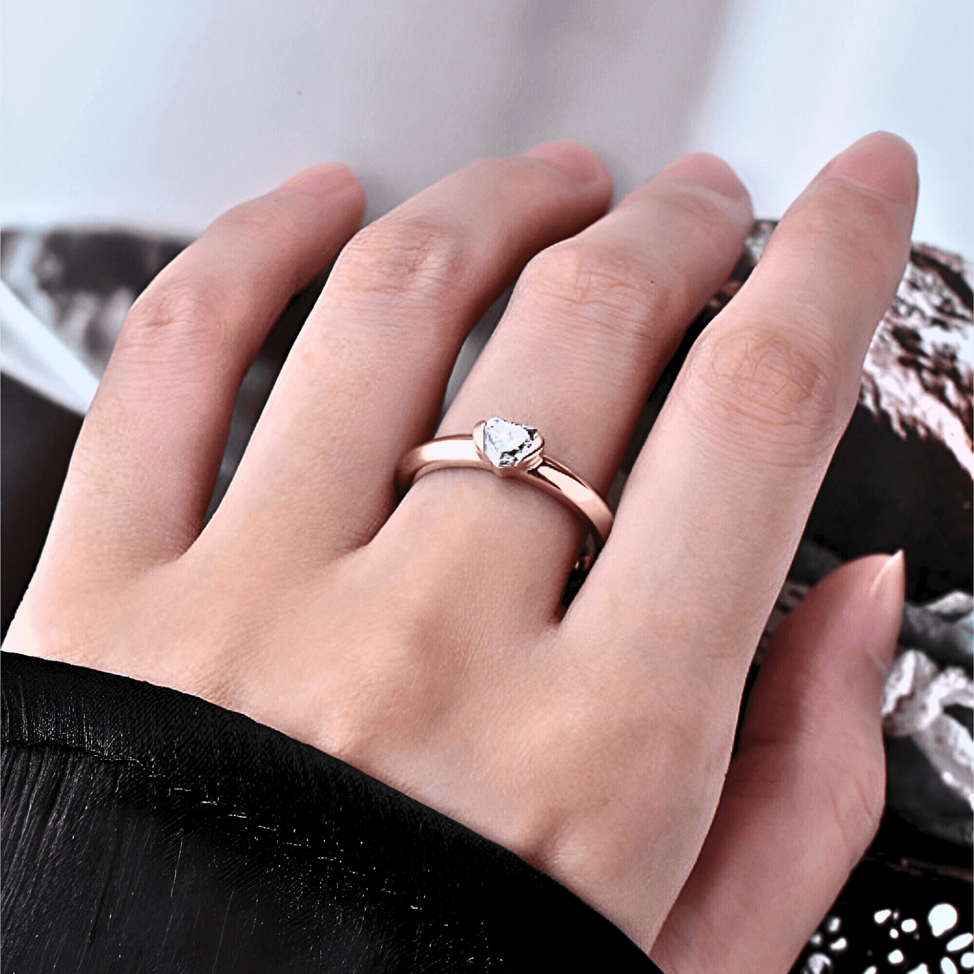 model wearing the Sylvie Ring 0.5ct - Rose Gold Ring featuring a heart shaped moissanite stone.