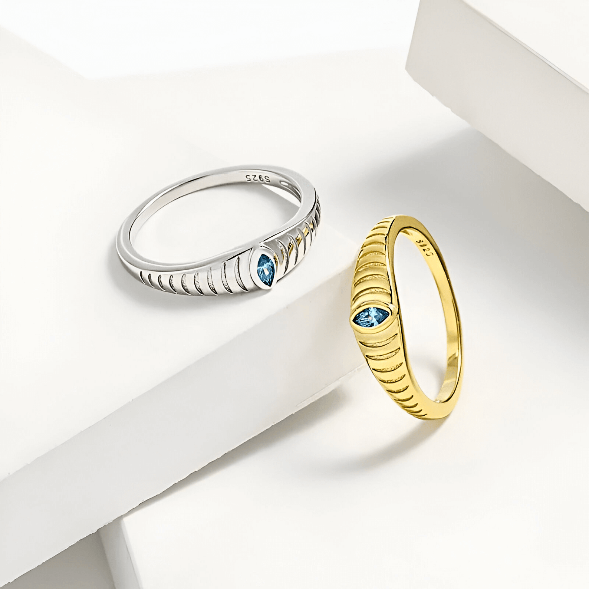 Iridian Band featuring blue zircon set in 18k gold and 925 sterling silver etched design.