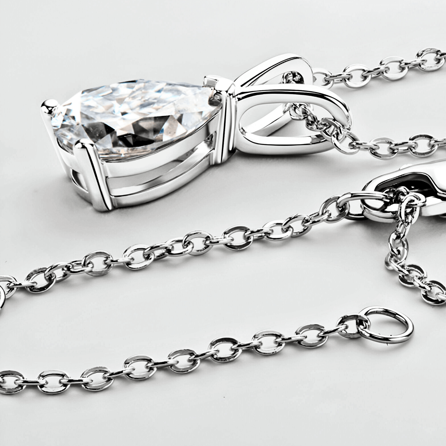 close up of the Mira Pendant 1.5ct - Teardrop necklace in polished 925 sterling silver with 1.5 carats of white moissanite.