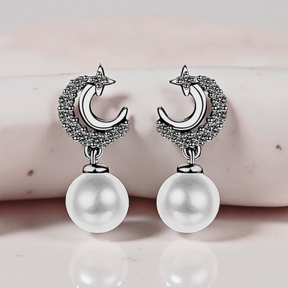 Lunetta Drops - Moissanite Pearl Earrings in 925 sterling silver. Featuring a silver crescent design with freshwater pearls.