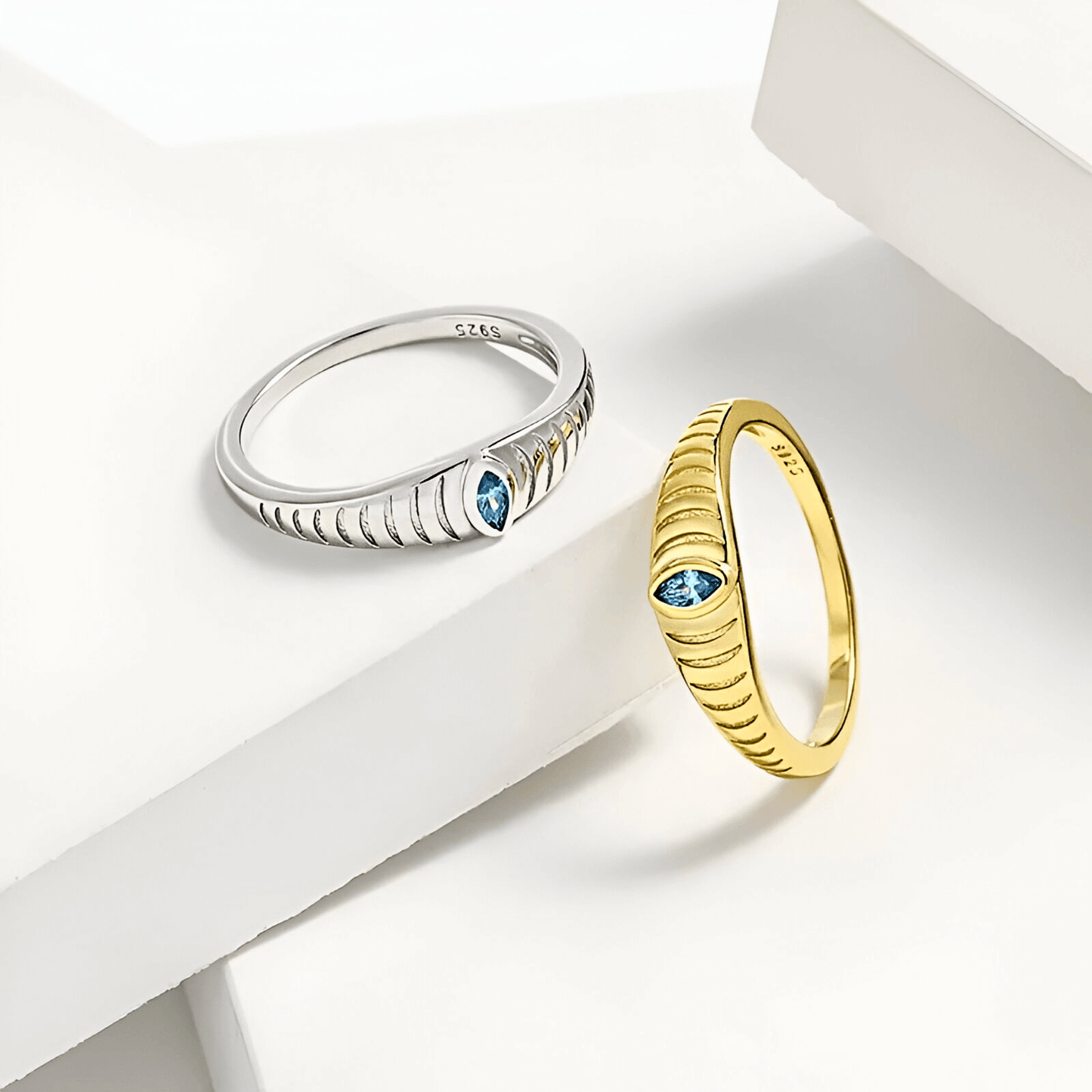 Iridian Band featuring blue zircon set in 18k gold and 925 sterling silver etched design.