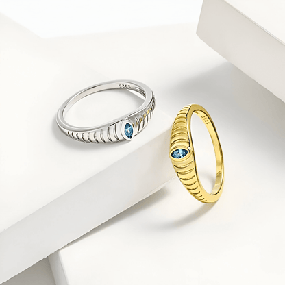 Iridian Band featuring blue zircon set in 18k gold and 925 sterling silver etched design.