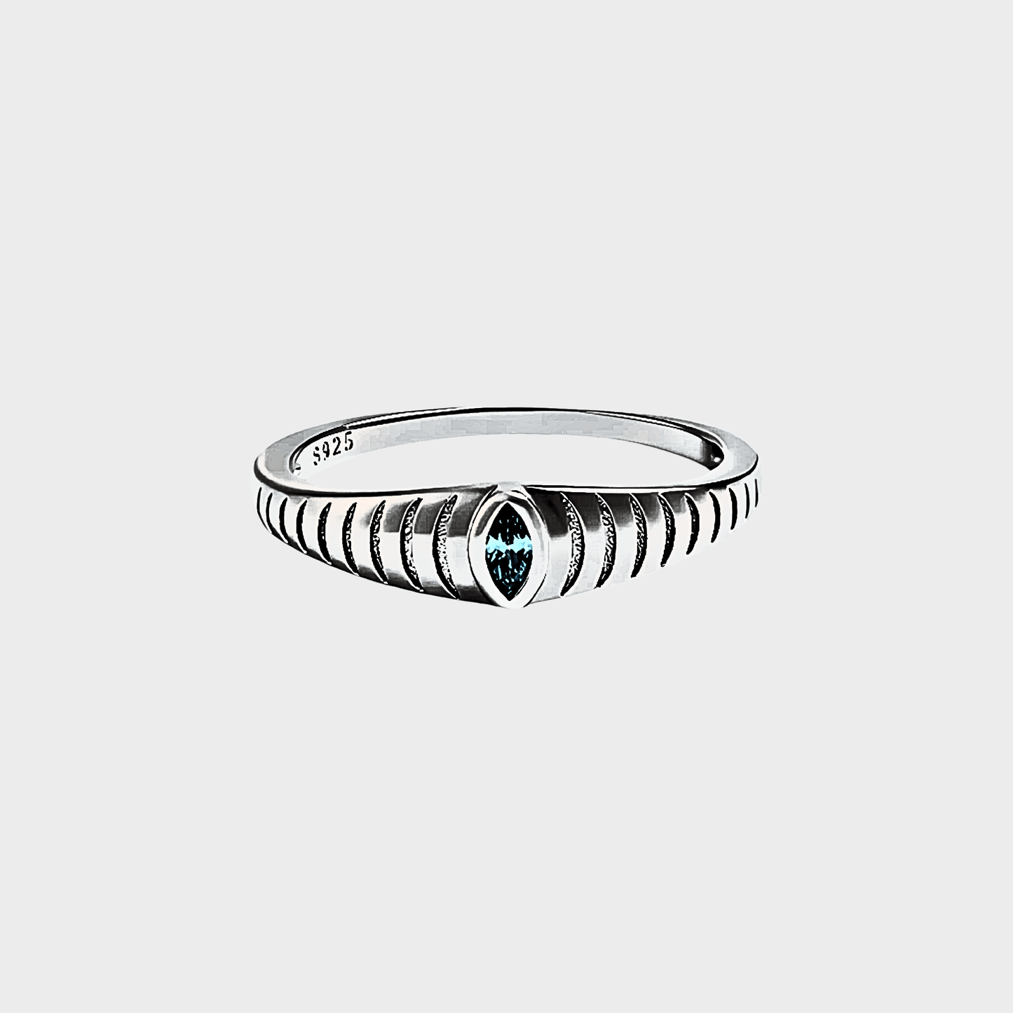 Iridian Band featuring a blue zircon in marquise cut, etched design on 925 Sterling Silver band.